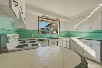 Original tiled countertops and backsplash mark the era too.