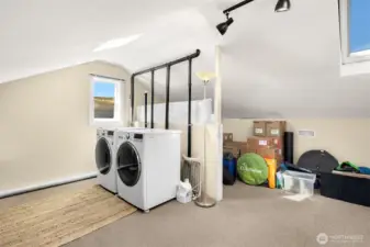 Upstairs attic has it's own washer and dryer and pre-plumbed for adding a full bathroom (washer and dryer would need to move to the opposite wall) while still leaving lots of bedroom or office space. New insulation and lovely skylights also added.