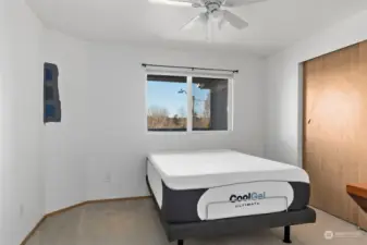 Primary bedroom with ceiling fan.