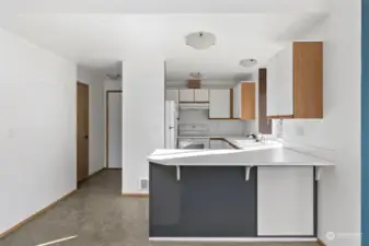 Kitchen with vinyl flooring and breakfast bar.