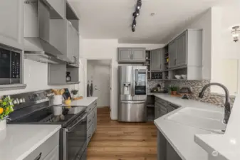 Kitchen has been fully remodeled with smart appliances, quartz countertops and subway tile.