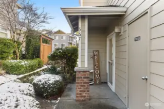 Covered entryway. Front door has glass and screen door.