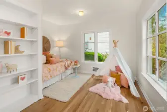 This second bedroom includes built-in library shelving.