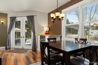 The informal dining area looks out to the side yard and is just beyond the eating bar off the kitchen.