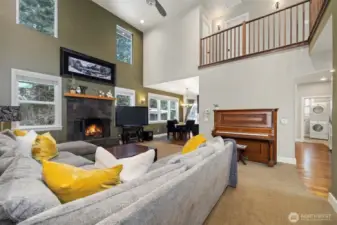 Looking across the living room toward the formal dining area and the laundry room to the right, just off the kitchen.