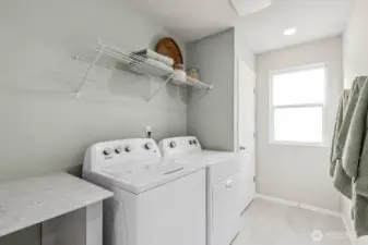 Great utility room located on upper level. Handy closet and counter for folding.  Colors and options will vary. Photos from Model Home on 30. Homesite 77 is a mirror image.