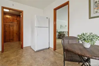 Left of the new fridge is the entry from the good-sized utility room.
