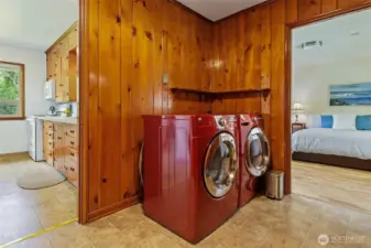 Looking back on kitchen and into serene primary bedroom. Laundry is so conveniently situated.