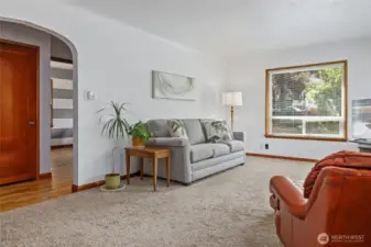 Coved ceilings, and archway into hall from spacious, light, bright living room