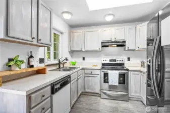 The kitchen has plenty of counter space for prepping meals and cooking.