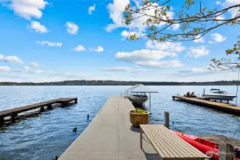 A private dock with a covered 5,000 lb boat lift, a swimming platform and hot tub on water's edge completes this rare lakeside retreat.