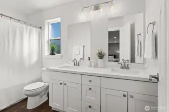 Bright and airy ensuite with double quartz vanity—perfect for busy mornings or winding down at night.