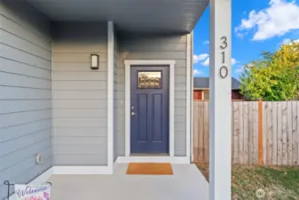 Covered porch welcomes you home with room to showcase your seasonal style.