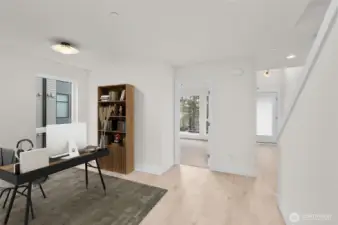 This photo is virtually staged.   Upon entry, you are greeted by two guest bedrooms + flex space, which can be used as a home office! This image is virtually staged.