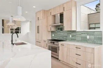 Black hardware complements the light wood cabinetry & stainless steel appliances.