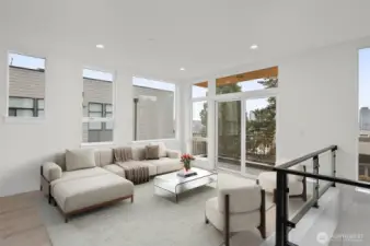 This photo is virtually staged.   Cozy up in the spacious living area with private deck! This image is virtually staged.