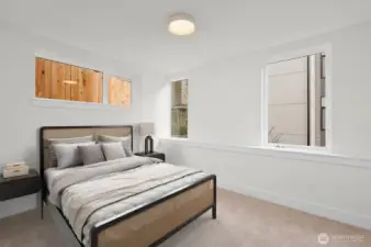 The additional guest bedroom on entry level provides privacy and convenience. This image is virtually staged.