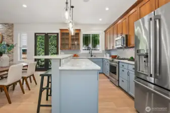 Recently remodeled kitchen follows all the current trends with high-end stainless steel appliances & big breakfast bar.