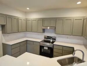 This is the color of the kitchen in this unit. Same material as unit B just painted.