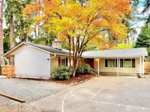 Welcoming front entry framed by lush greenery