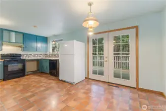 Kitchen with eating space and French doors that open to the deck.