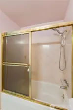 Bathtub/shower in main bathroom.