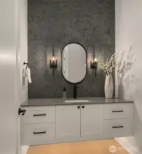 Stylish powder room with designer vanity and statement lighting.