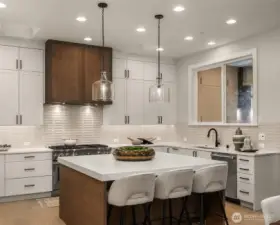 Chef’s kitchen with oversized island, premium finishes and appliance package.