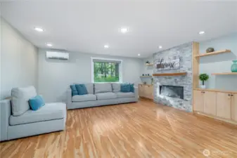 Gorgeous open concept LR with custom shelving and fireplace