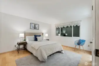 Retreat to this comfortable and serene primary bedroom filled with natural light, making mornings and evenings feel easy.