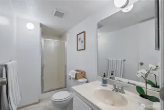 A functional lower-level bathroom designed for convenience, complete with shower and vanity space.