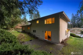 Spacious backyard setting with patio access, offering endless potential to create your ideal outdoor retreat.