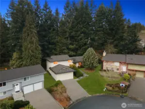 Tucked into a quiet setting and surrounded by mature evergreens, this home offers a peaceful neighborhood feel with natural privacy.