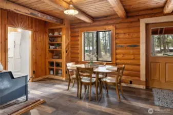 The dining area feels open and spacious, with handy built-ins and open shelving.