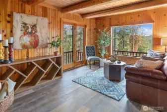 The Spacious living room with double door leading to the deck.