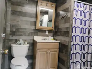 convenient bathroom with a shower and laundry room