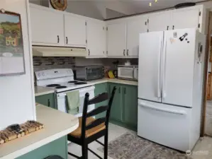 Another Different View of the Kitchen Showing Newer Range and Refrigerator.