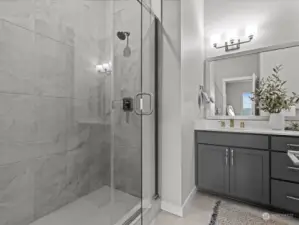 Large modern walk-in shower and double sinks.