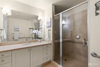 The 3/4 bathroom offers a spacious vanity with plenty of counter space and includes safety grab bars in the shower area as well as next to the Japanese washlet bidet for added comfort and security.