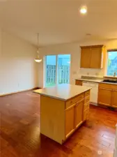 Kitchen island with eating bar and open to kitchen and dining area.