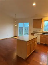 Kitchen island with eating bar and open to kitchen and dining area.