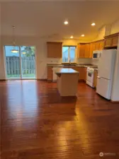 Kitchen island with eating bar and open to kitchen and dining area.