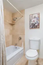 Bathtub/shower with    tile surround and toilet separate from vanity