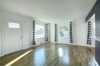 Open concept living space with large windows.