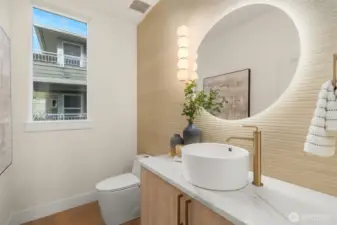 Main-level powder room with modern floating vanity and artistic wall detail.