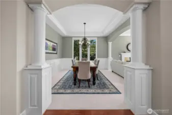 Grand view into the dining area framed by architectural columns, showcasing timeless design.