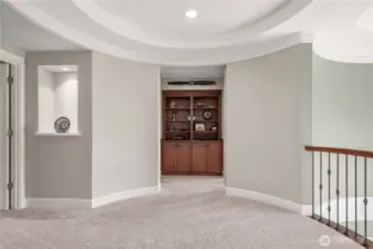 A custom built-in bookcase with rich cabinetry provides the perfect display for books, décor, or collectibles.