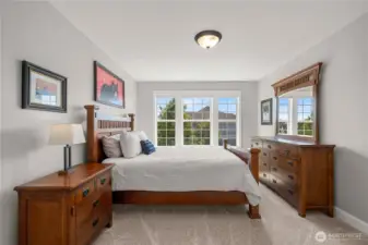 Spacious and inviting bedroom with large windows and plenty of room for personalization.