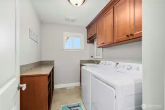 Upstairs convenience with built-in cabinetry, folding counter, and natural light.