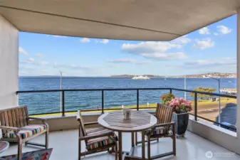 Welcome to Bay Villa! This beautifully appointed 4th-floor condo offers two spacious bedrooms plus a versatile home office/media room. Enjoy the convenience of two prime parking spaces, including one with EV charging. The expansive, view-facing primary suite showcases sweeping vistas of the Olympic Mountains, the Space Needle, and Puget Sound, creating a stunning backdrop for everyday living.